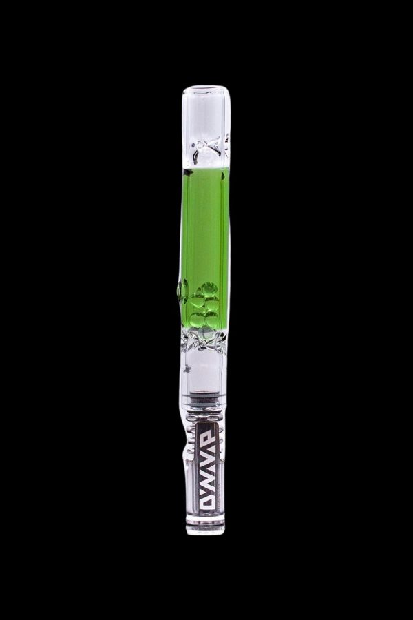 Glass cannabis oil rig with green accents and a skull design, isolated on a black background.