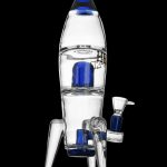 Glass rocket ship-shaped water pipe with blue accents, displayed on a black background.