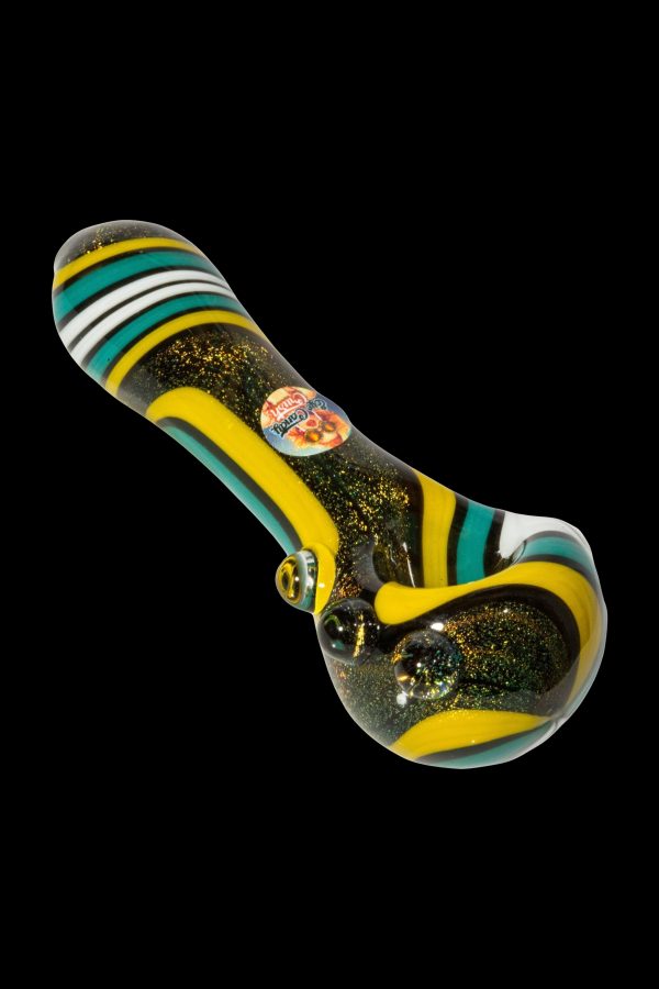 A colorful glass pipe with turquoise, yellow, and black stripes against a black background.