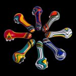 Colorful glass smoking pipes arranged in a circle on a black background.
