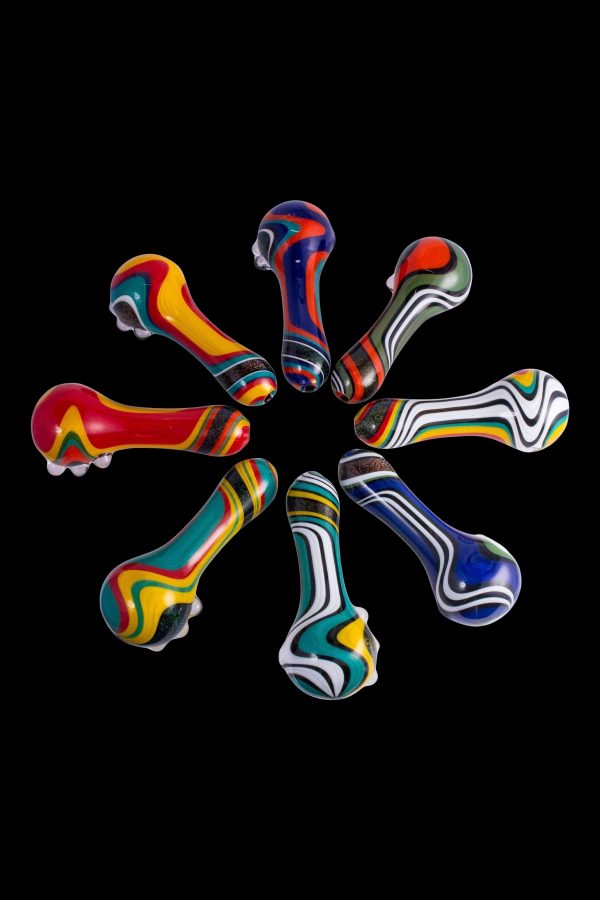 Colorful glass smoking pipes arranged in a circle on a black background.