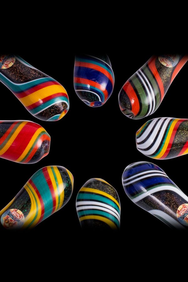 Colorful glass pipes arranged in a circle on a black background.