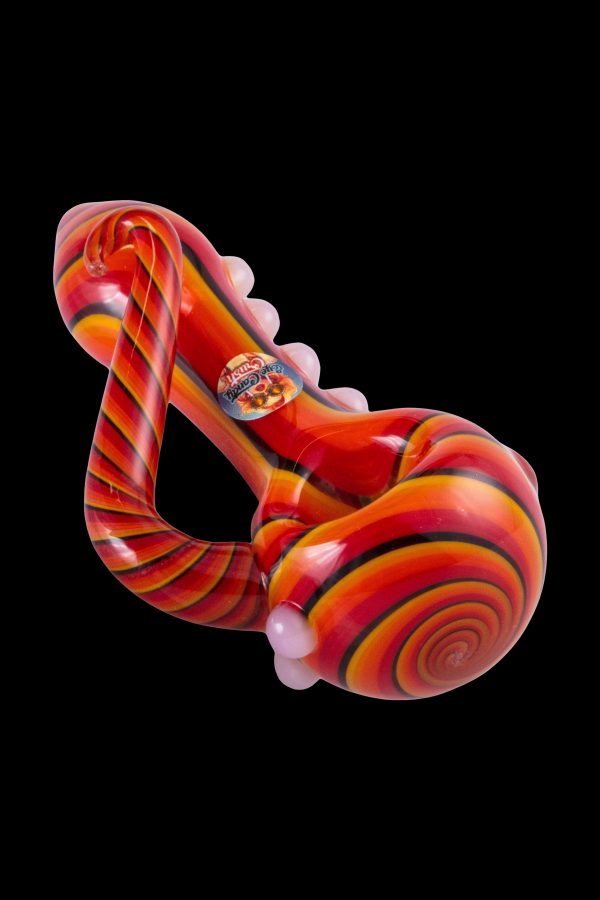 Red and white glass cannabis water pipe with swirling patterns.