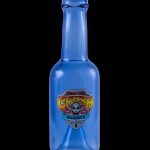 Blue glass bottle with a retro-style “Toxic Crush” label featuring a skull and crossbones, likely used for cannabis concentrates.