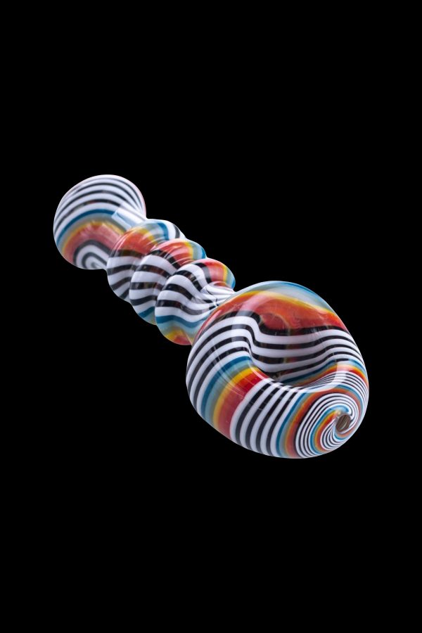 Colorful glass pipe with swirling stripes against a black background.