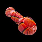Red and orange swirled glass bubbler pipe against a black background.