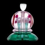 Hand-blown glass bubbler with pink polka dots and a green base.