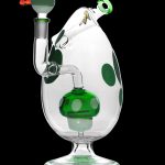 Clear glass water pipe with green polka dots and accents, featuring a complex percolator system.