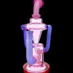 A colorful glass dab rig with a unique looped design, featuring pink, purple, and blue hues.