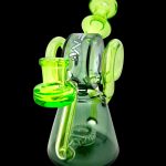 Green glass water pipe (rig) with intricate looping design.