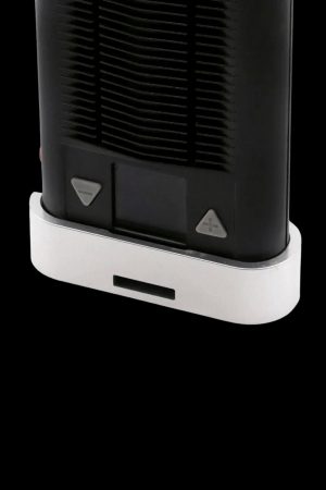 Close-up of the base of a sleek, black cannabis vaporizer with white accents and control buttons.