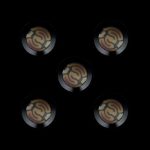 Five metallic cannabis oil cartridge caps with embossed swirling designs against a black background.