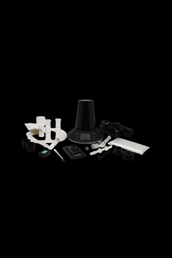 Cannabis vaporizer device and accessories displayed on a black surface.