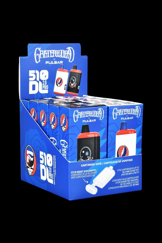 A stack of boxed Pulsar ""510 Duo Pro"" cannabis oil vape cartridges featuring Grateful Dead-themed branding."