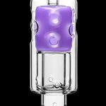 Purple cannabis oil concentrate inside a glass dab rig.