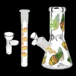 Glass bong and downstem decorated with pineapple designs, isolated on a white background.