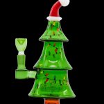 A glass cannabis water pipe shaped like a Christmas tree, adorned with colorful lights and a Santa hat.