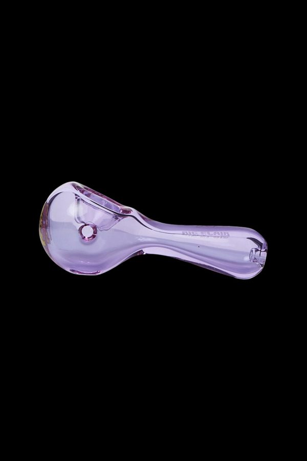 Purple glass smoking pipe isolated on a black background.