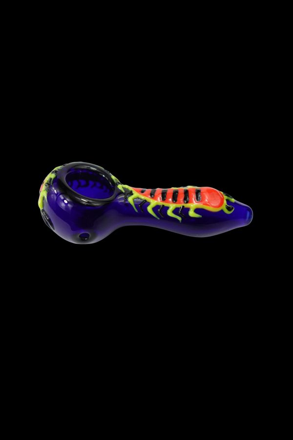 Glass pipe with a vibrant spider design, isolated on a black background.