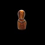 Amber glass pipe isolated on a black background.