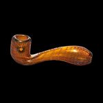 Ornate orange glass pipe against a black background.