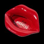 Red lips-shaped cannabis pipe with “Highness NYC” branding against a black background.