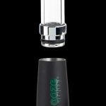 Black and clear glass oil rig dab attachment with green logo.