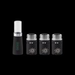 Black cannabis oil cartridges and a charging base on a dark background.