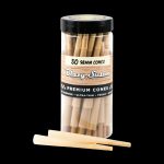 A clear plastic tube filled with 50 unlit, rolled paper cones for smoking, labeled "Blazy Susan Premium Cones." One cone is laid out beside the tube.