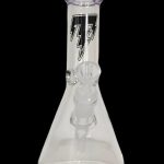 Clear glass beaker bong with purple accents and intricate internal diffusion perc, isolated on a black background.