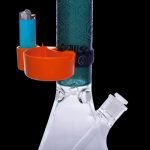 A glass bong with an orange catchall for accessories and a lighter, set against a black background.