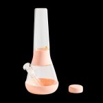 Peach-colored glass bong with a removable downstem and cap, isolated on a black background.