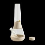 Beige and clear glass bubbler water pipe with a removable downstem and silicone stopper, isolated on a black background.