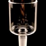 Clear glass bubbler for smoking, against a black background.