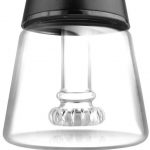 Close-up of a glass dab rig with a quartz banger inside, branded “ROK.”