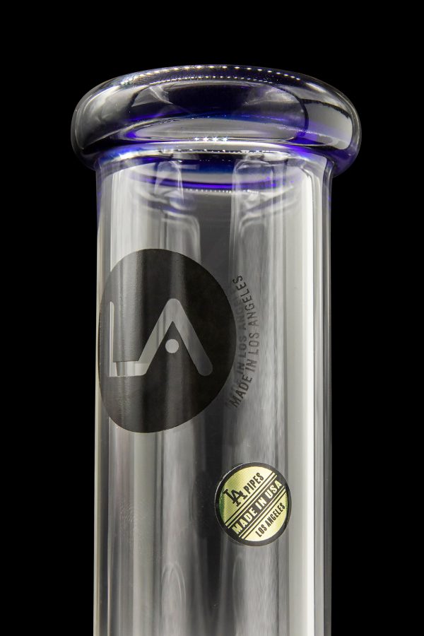 A clear glass water pipe with blue accents, featuring a black "LA" logo and "LA PIPES MADE IN USA LOS ANGELES" text.