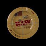 A circular package of RAW Natural Rolling Papers against a black background.