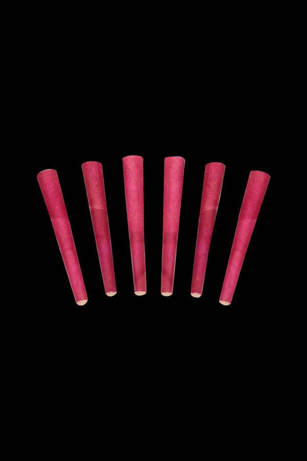 Seven pre-rolled, maroon-colored cannabis cones against a black background.