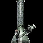 Green glass water pipe with camouflage pattern and cannabis leaf design.