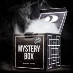 Open black box labeled “Mystery Box” with smoke rising from within, suggesting cannabis accessories inside.