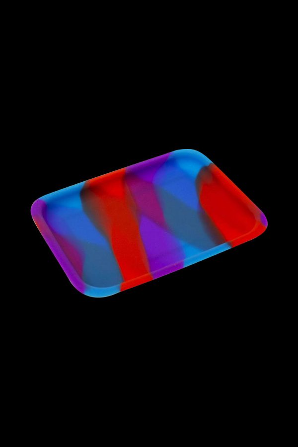 Close-up of the Silicone Concentrate Tray, showcasing its smooth, dark surface and minimalist design against a black background.
