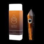 A boxed gemstone pipe, specifically “Tiger Eye”, from Astral Project, displayed against a black background.