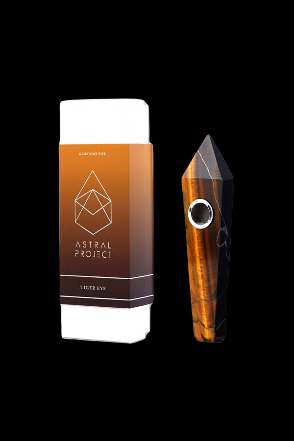 A boxed gemstone pipe, specifically “Tiger Eye”, from Astral Project, displayed against a black background.