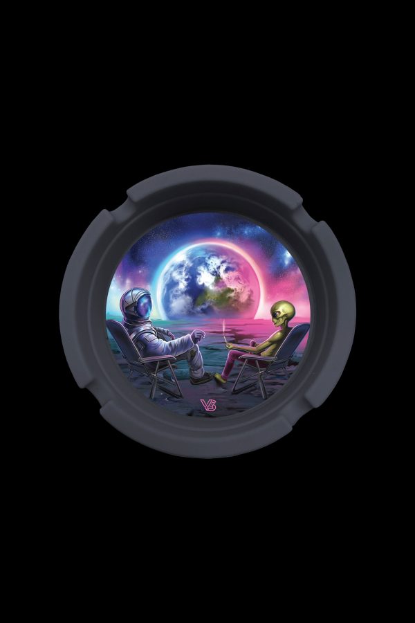 A circular cannabis ashtray depicts an astronaut and alien relaxing in lawn chairs on the moon, gazing at Earth amidst a vibrant, cosmic backdrop."