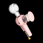 Pink silicone dab rig with glass bowl and carb cap, isolated on a black background.