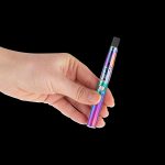 Hand holding a colorful, metallic cannabis vaporizer pen against a black background.