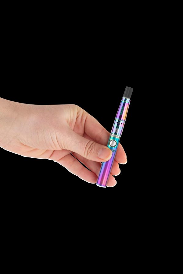 Hand holding a colorful, metallic cannabis vaporizer pen against a black background.
