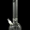 Clear glass water pipe (bong) with intricate swirling patterns and a diffused downstem, isolated on a black background.