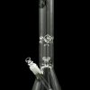 Clear glass bong with intricate detailing and a green accent, isolated on a black background.